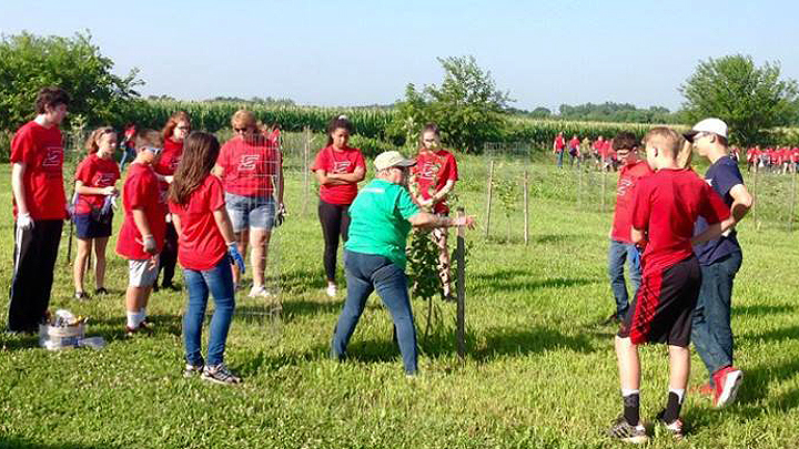 This is a picture of an adult Silverwood Park volunteer with Edgerton High School volunteers.