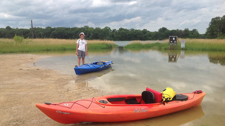 This is a picture of a kayak paddler on Rice Lake at Silverwood Park.