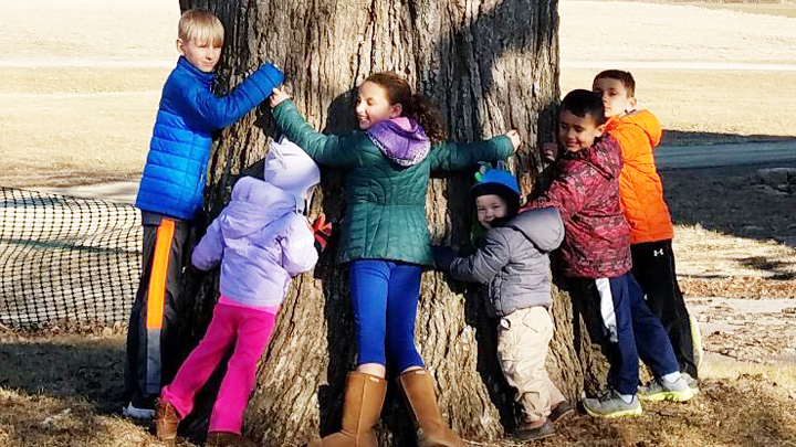 This is a picture of children at Silverwood's Great Oak on Arbor Day 2018.