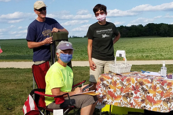 This is a picture of three Silverwood Park volunteers at a public event.