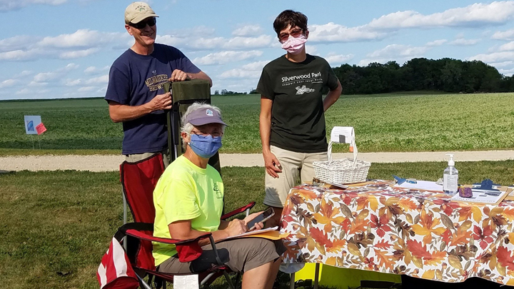 This is a picture of three Silverwood Park volunteers at a public event.