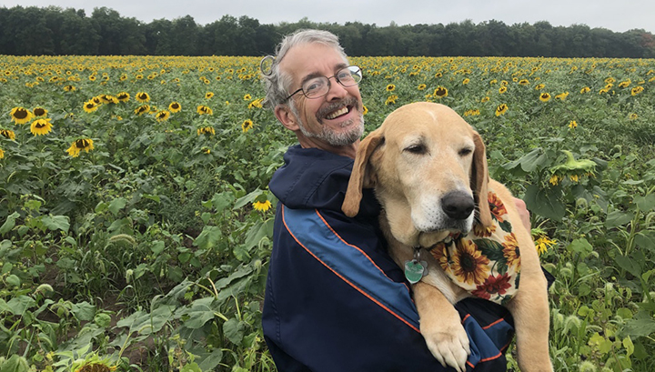 John with Honey Dawg, team member in charge of integrated pest management